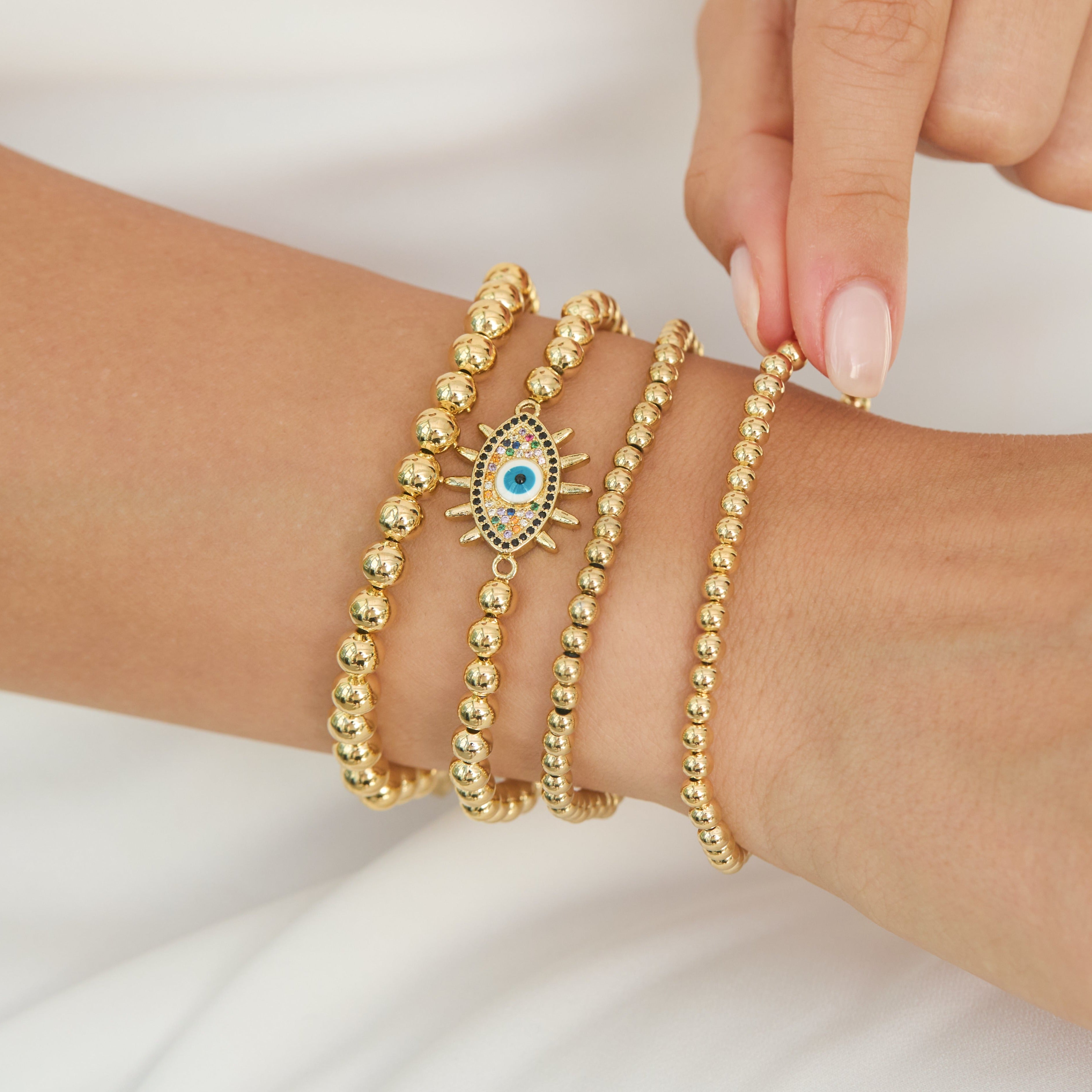 Gold beaded evil eye bracelet discount